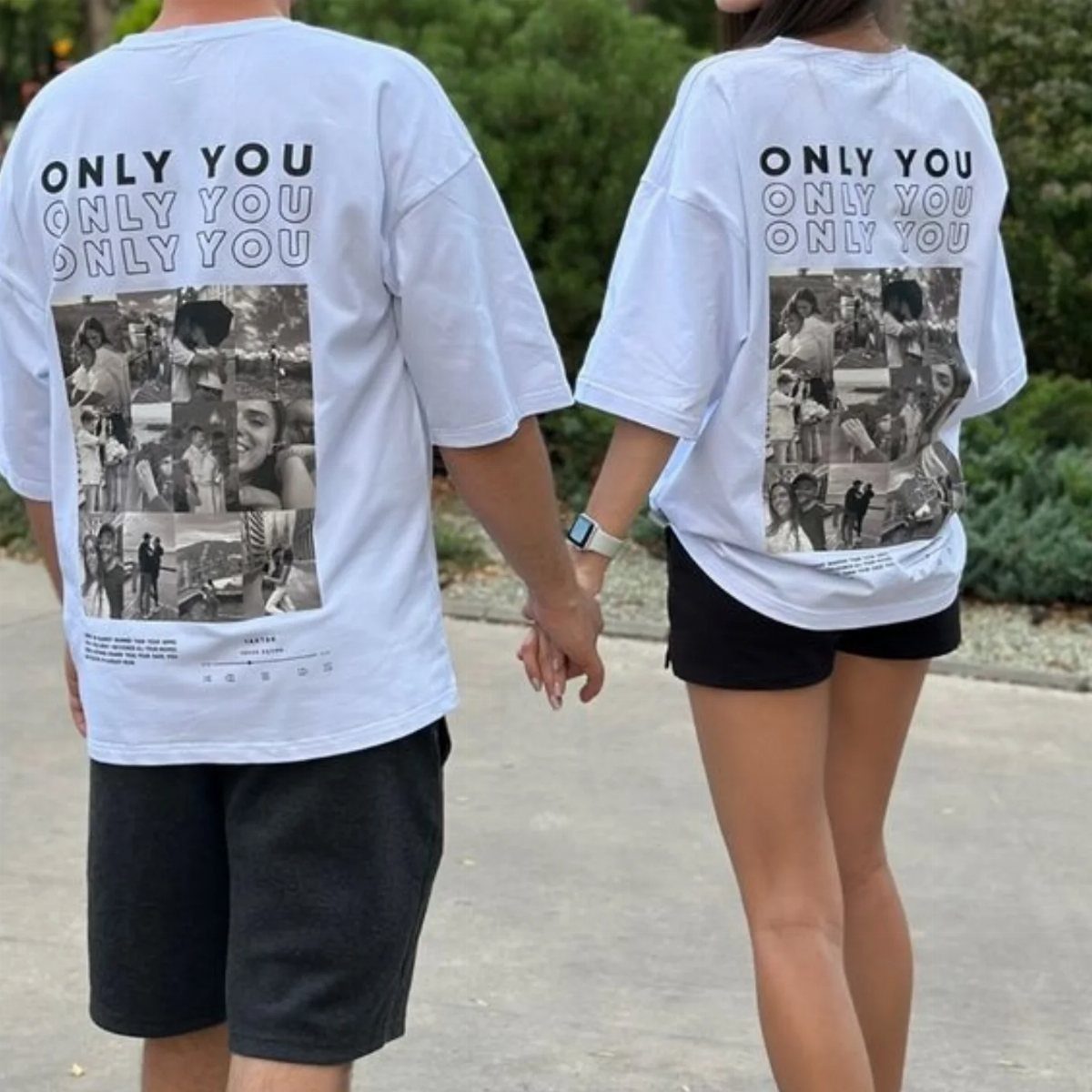 Couple holding hands wearing matching white t-shirts with photo collages on the back.