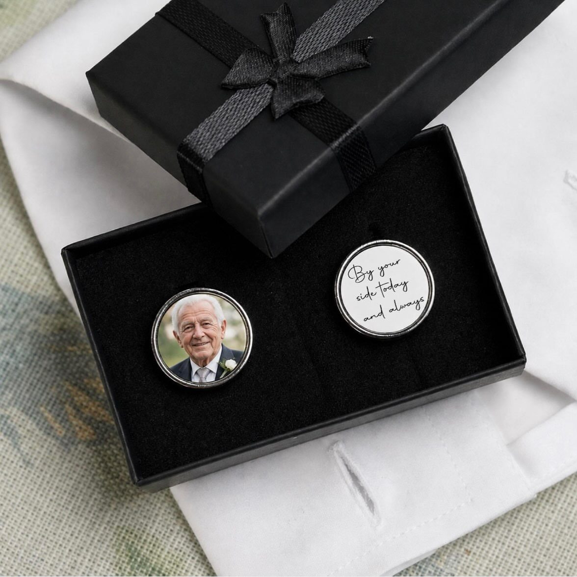 Silver cufflinks with a portrait and handwritten message in a black gift box.