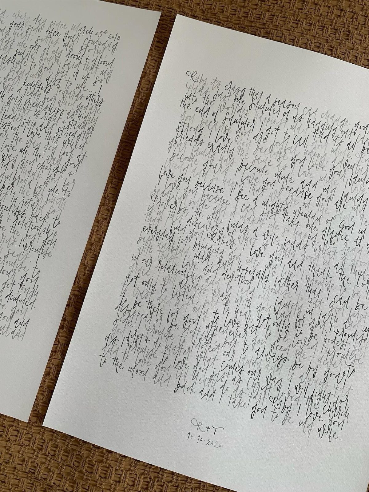 Handwritten letters on white paper resting on a brown textured fabric background.