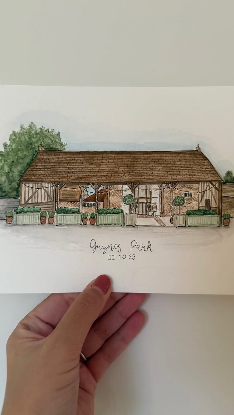 Watercolor illustration of a rustic barn venue held by a person's hand.