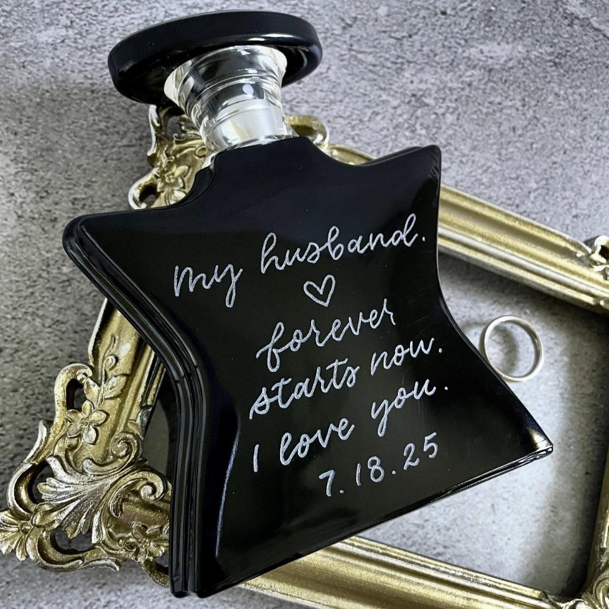 Black star-shaped decanter with personalized romantic text for a husband on gold frame