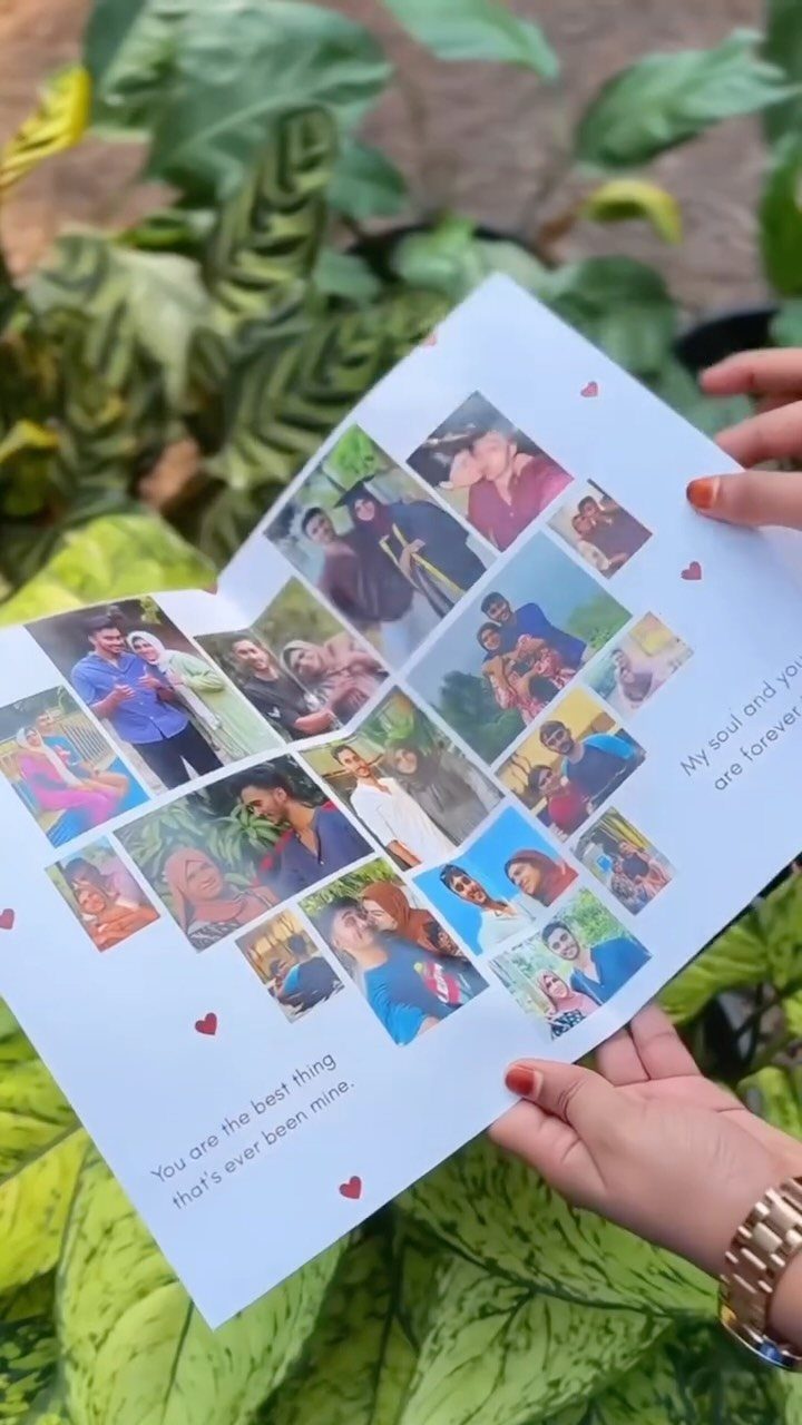 Handmade photo collage card with couple pictures and romantic text held over leaves.