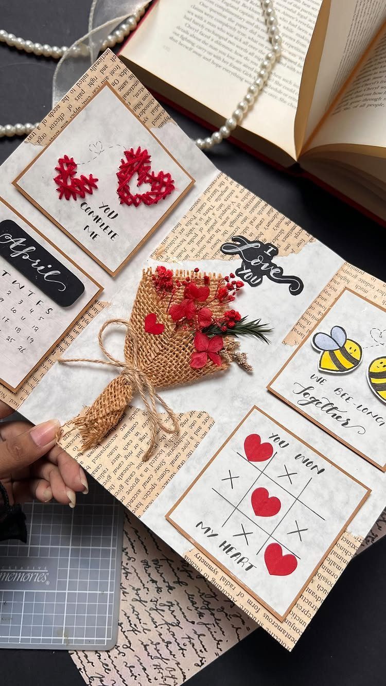 Handmade scrapbook page with red hearts, a small flower bouquet, and romantic notes.