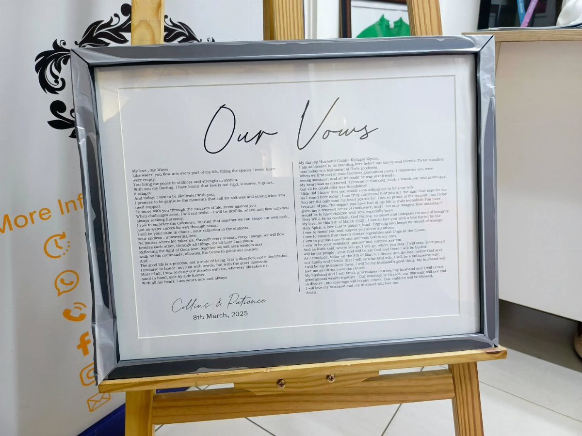 Framed wedding vows with elegant script resting on a wooden artist easel.