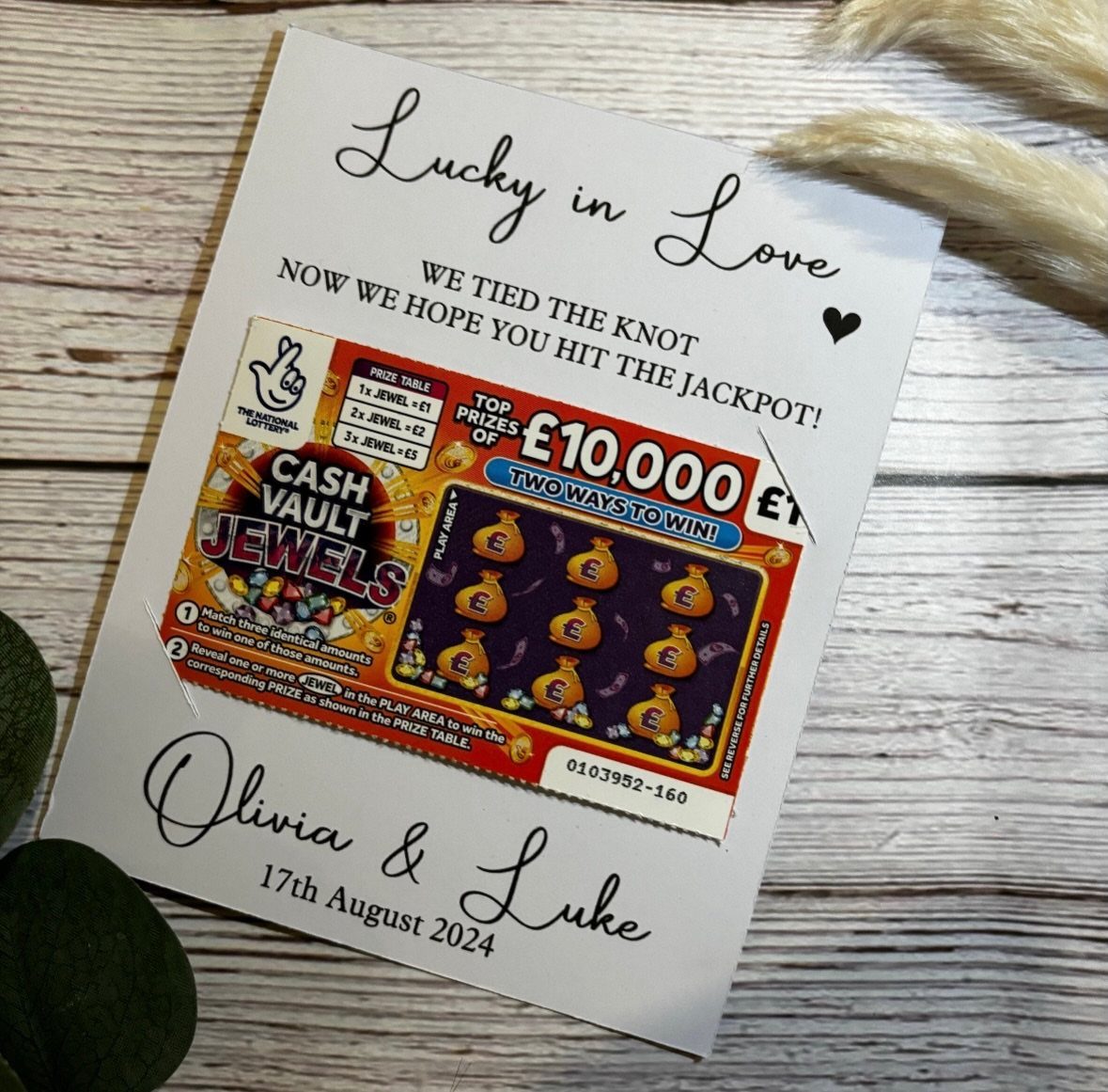 White anniversary card with a scratch-off lottery ticket glued to the center.