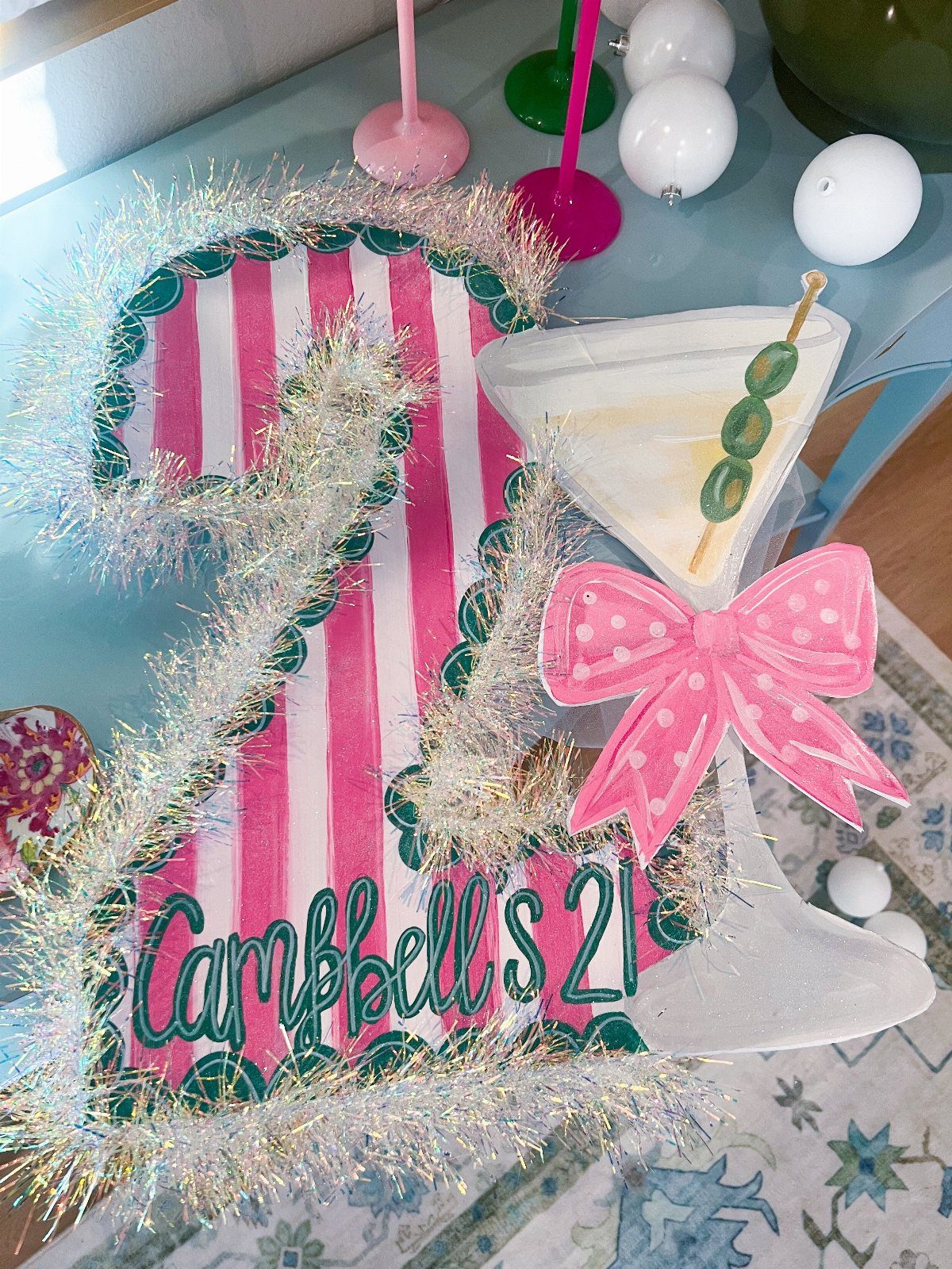 Painted number 21 birthday banner with pink stripes and a martini glass cutout.