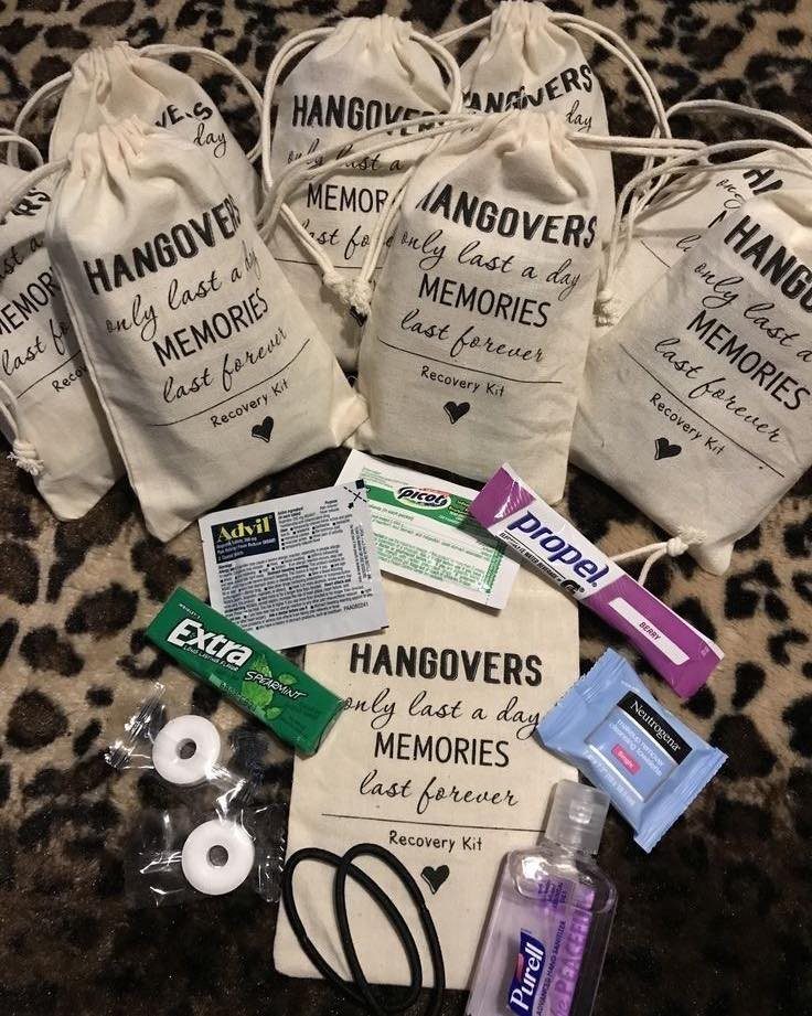 White drawstring recovery kit bags with hangover text and various health supplies.
