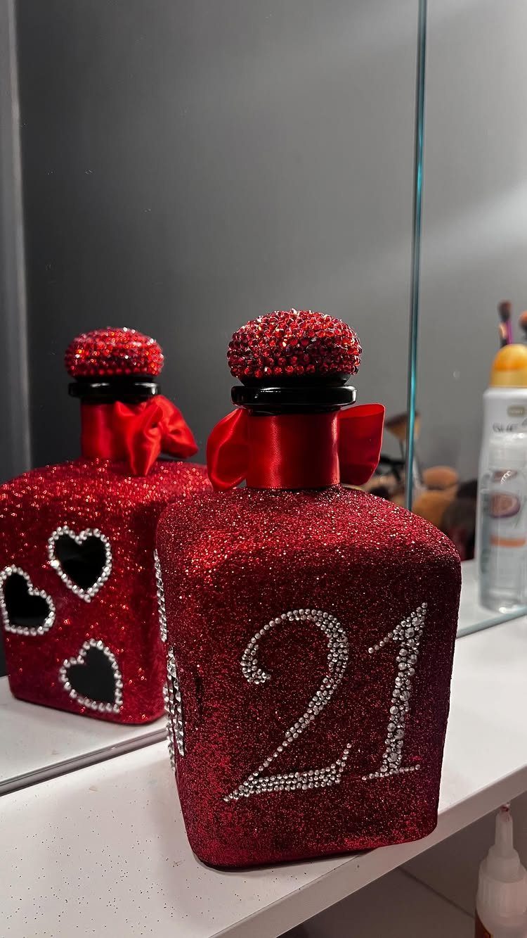 Red glittery bottle with silver rhinestone number 21 and red satin bow