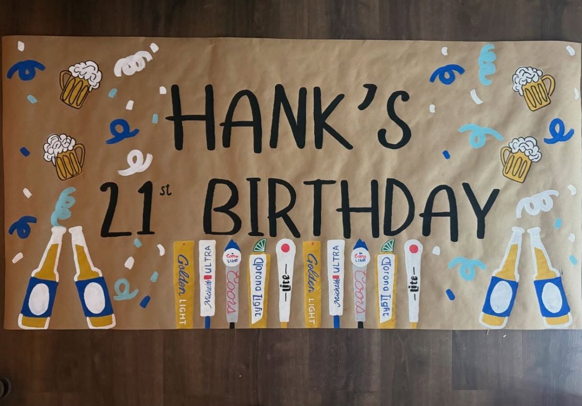 Hand-drawn birthday banner for Hank's 21st birthday featuring beer bottles and mugs.