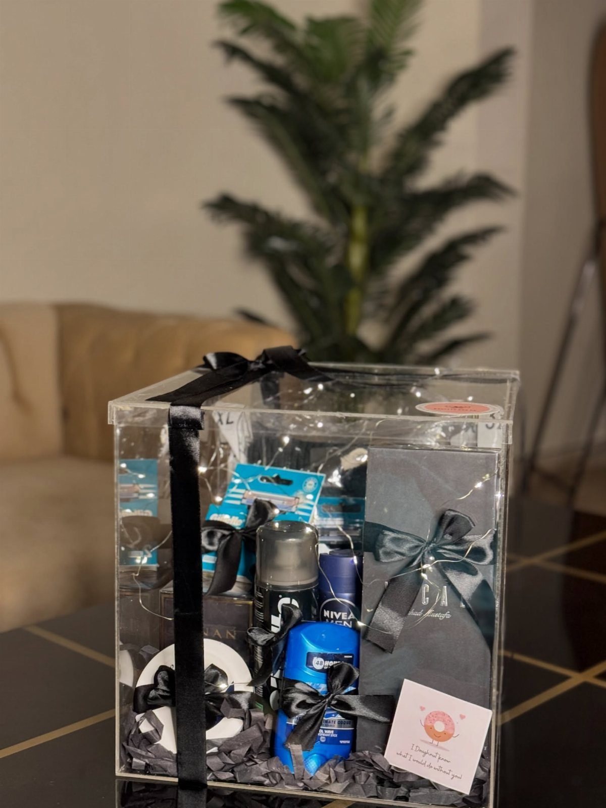 Men's grooming gift set in a clear acrylic box with black ribbon.