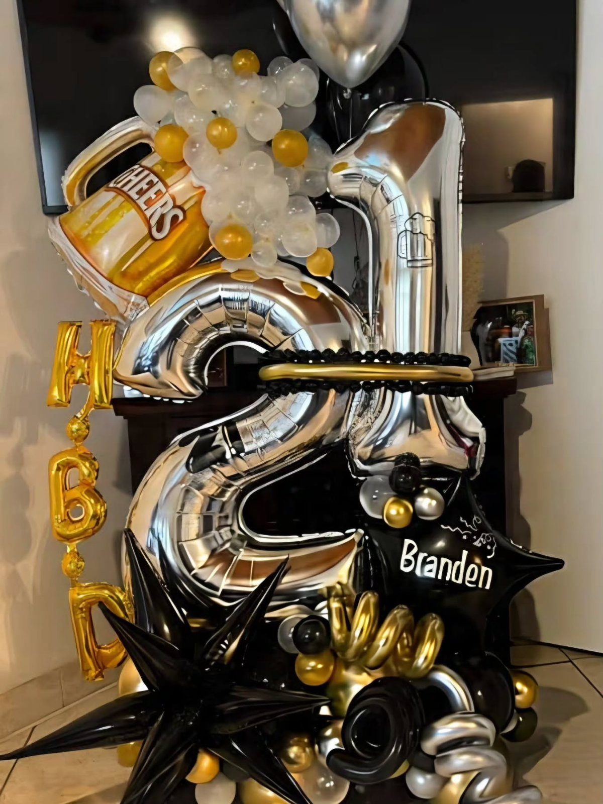 Balloon arrangement with silver number 21, gold beer mug, and personalized name balloon.