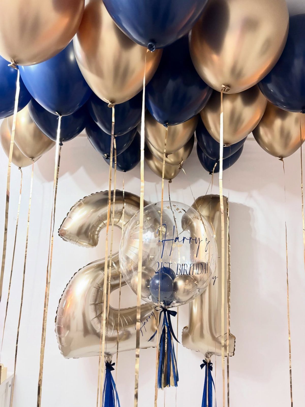 Gold and navy blue balloons with large gold foil number 21 balloons.