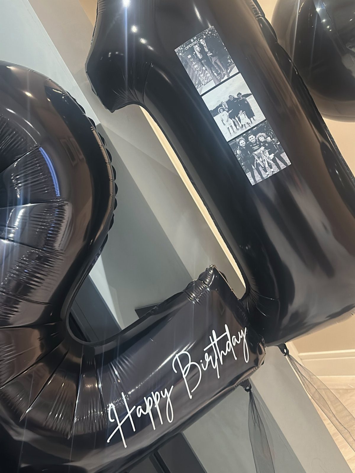 Black number 21 balloons with photos and Happy Birthday text for a celebration