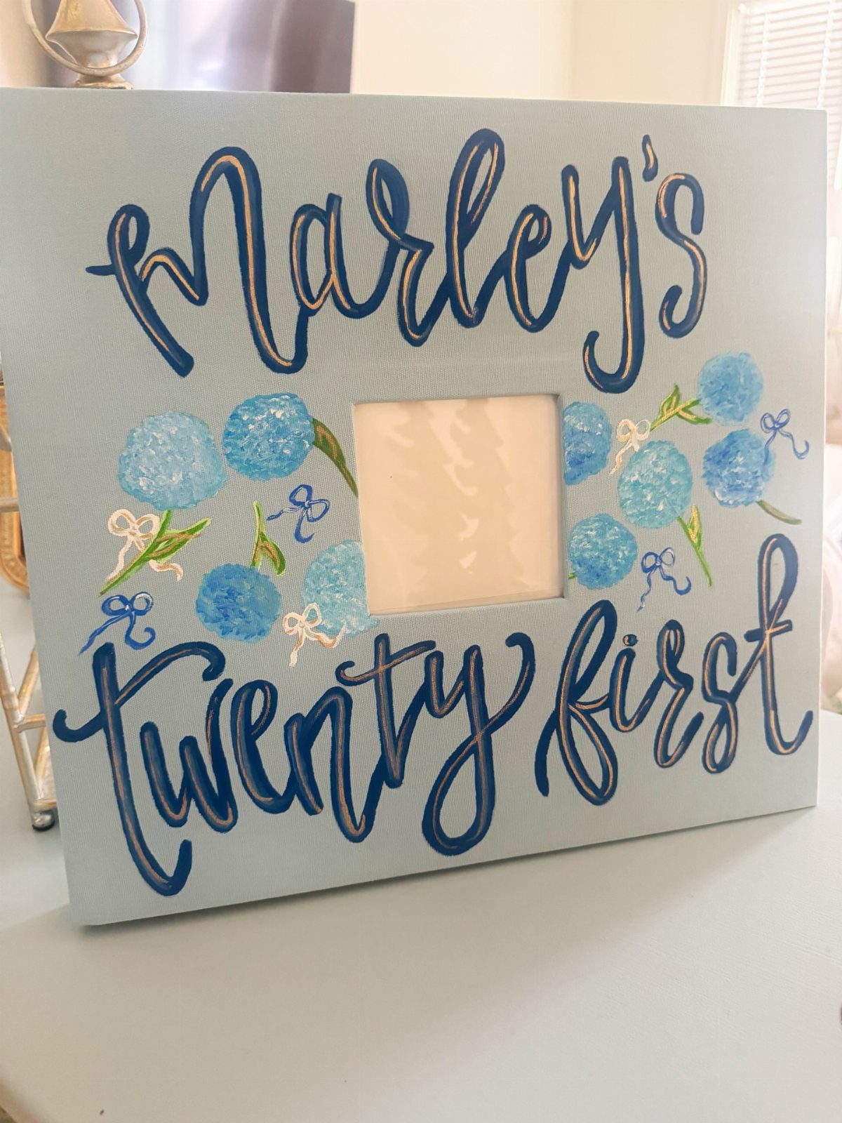 Blue 21st birthday shot book page with cursive lettering and floral decorations.