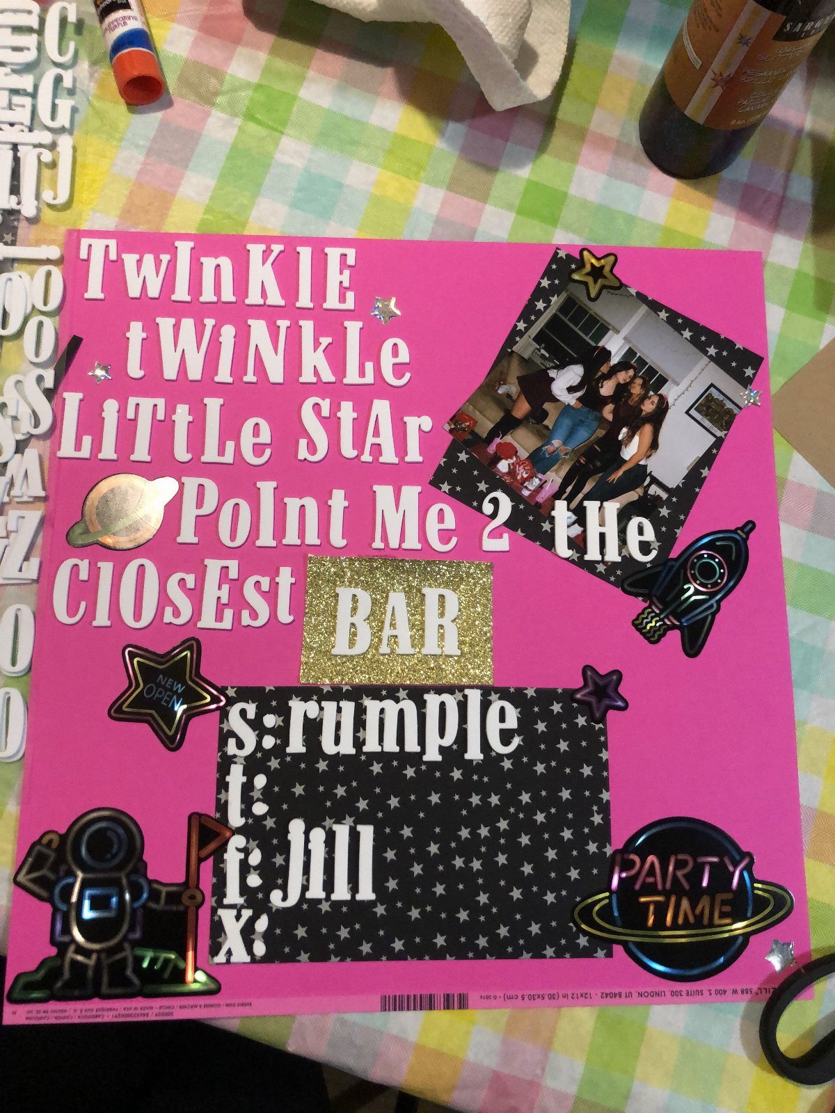 Pink cardstock page with gold glitter letters, photos, and space-themed stickers.