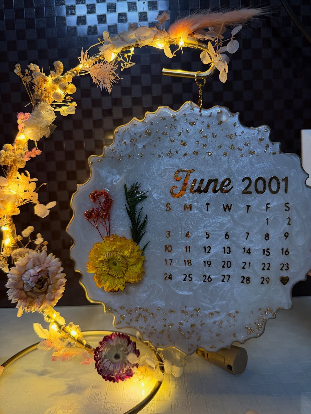 Resin calendar plaque for June 2001 with dried flowers and fairy lights.