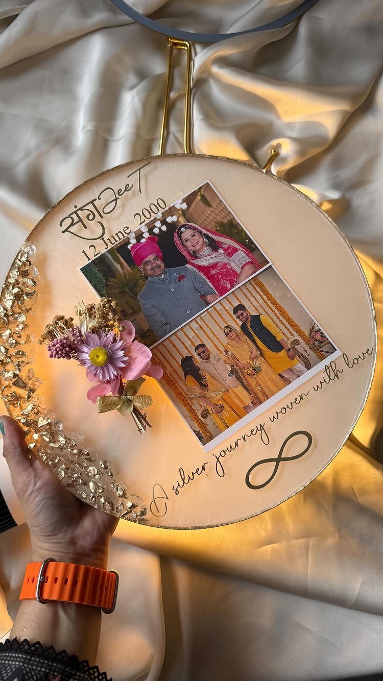 Circular anniversary plaque with wedding photos, dried flowers, and a silver journey inscription.