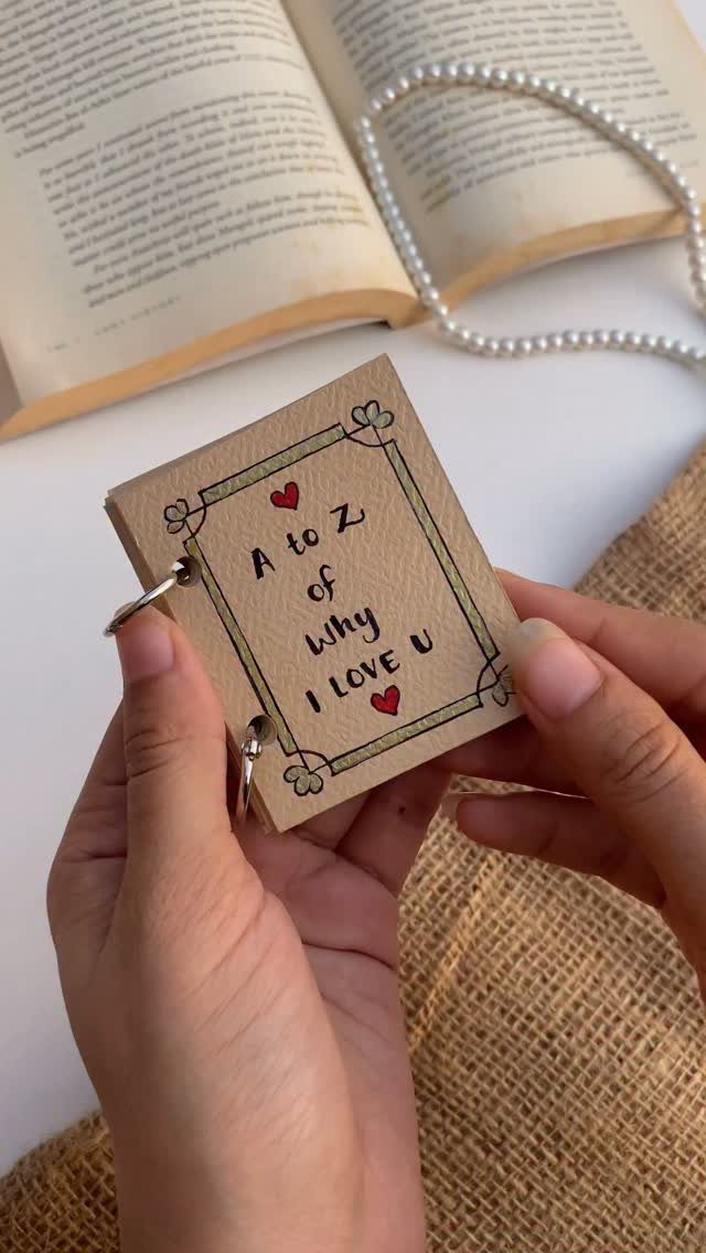 Handmade small brown notebook with a ring binder and romantic handwritten text.