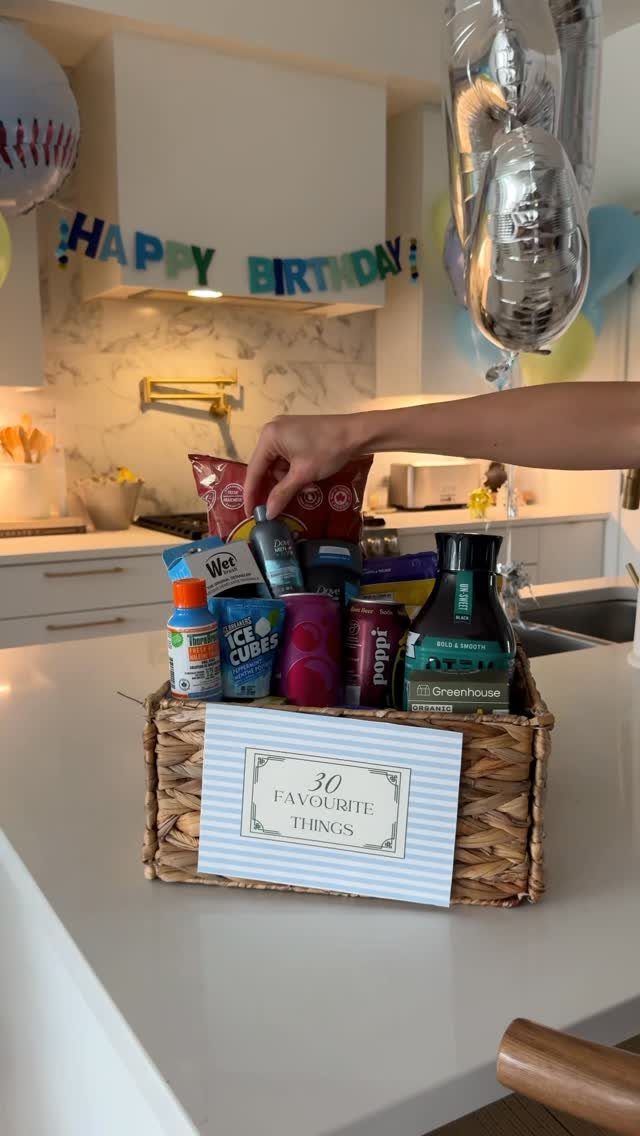 Wicker gift basket filled with snacks and a 30 Favourite Things sign.