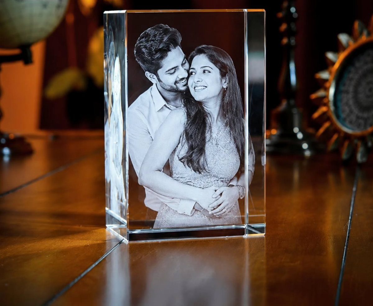 Crystal block with a 3D laser-etched photo of a couple embracing on wood.