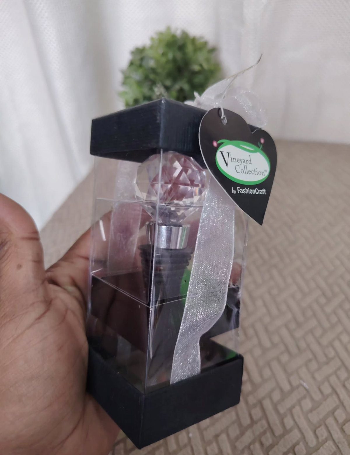 Perfume bottle with crystal cap in a black and clear gift box.