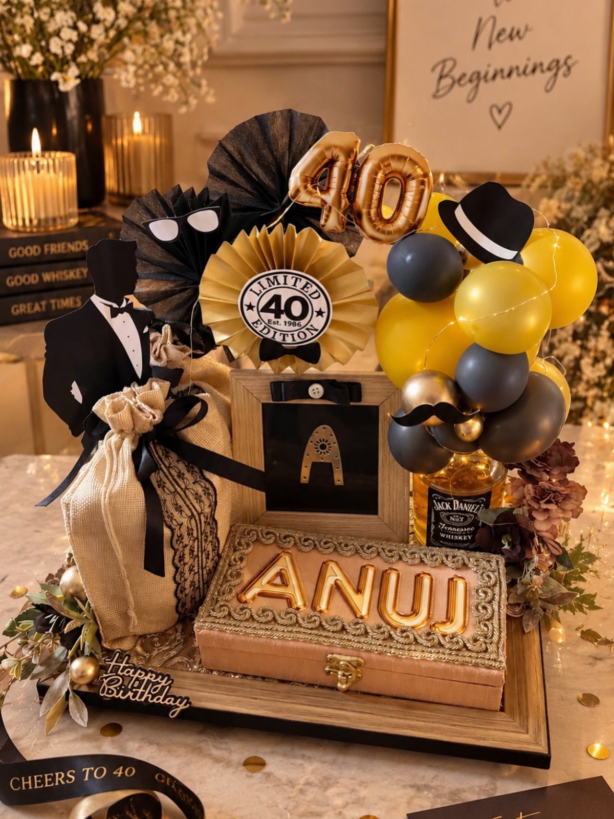 Birthday gift hamper with whiskey bottle, gold 40 balloons, and personalized name chest.