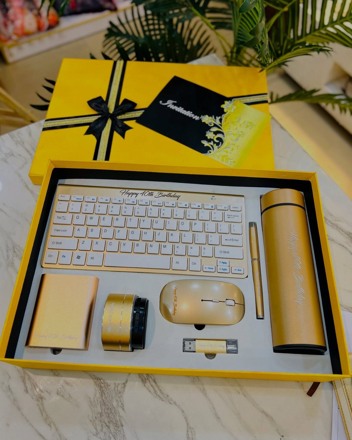 Gold tech gift set with keyboard and mouse in a yellow box