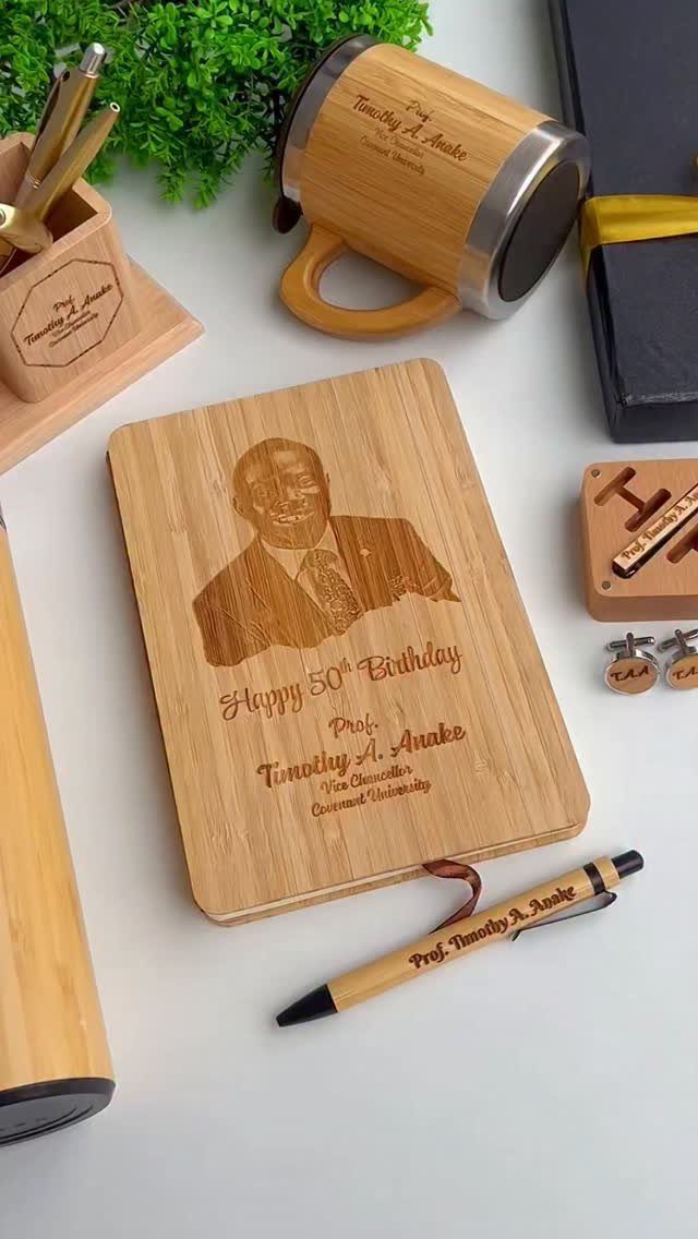 Personalized bamboo notebook with engraved portrait and 50th birthday message with matching pen.