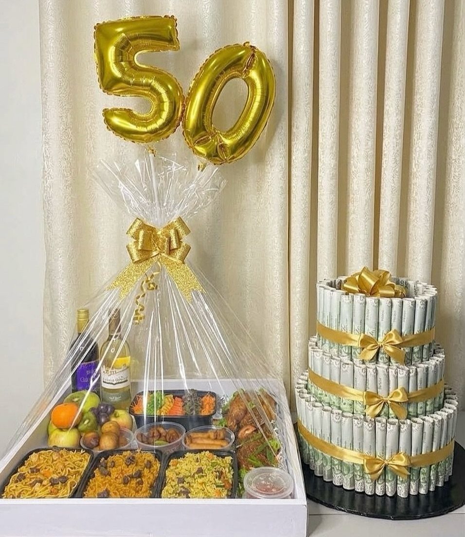 Gourmet food basket with wine and gold 50 balloons for a birthday celebration