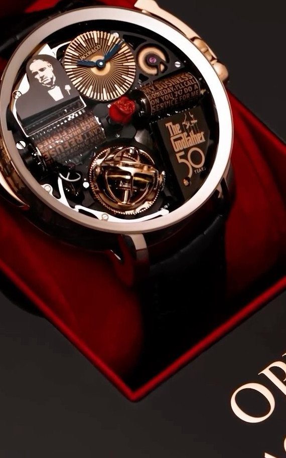 Luxury gold watch with Godfather theme and number 50 on red velvet