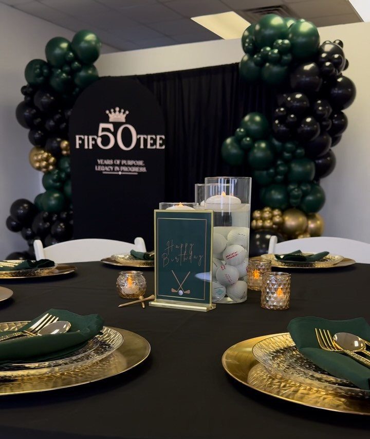 Golf themed 50th birthday party table with gold plates and golf ball centerpieces
