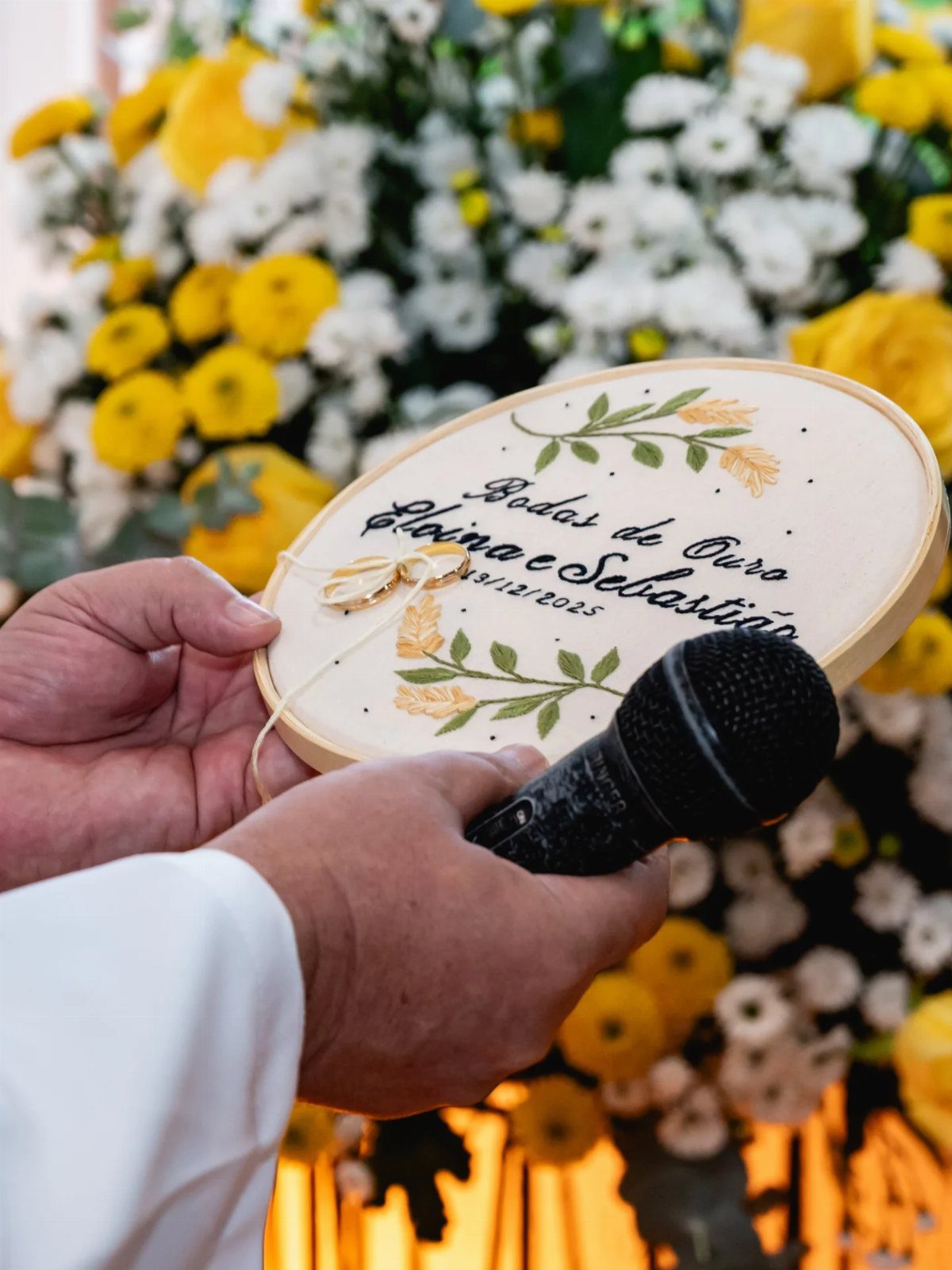 Wooden oval plaque for a golden wedding anniversary held against floral background