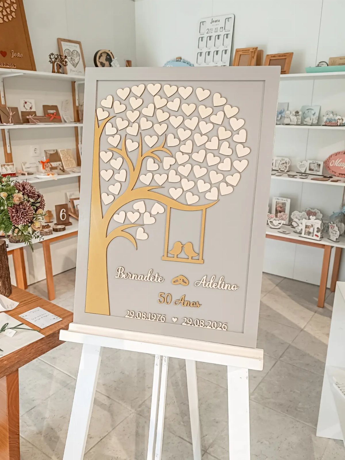 Gold wooden tree with heart leaves on a grey background for 50th anniversary.