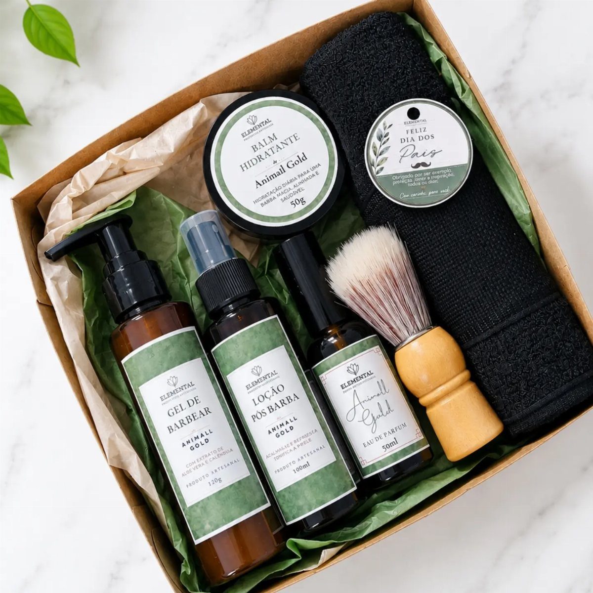 Grooming kit in a cardboard box with shaving brush, bottles, and black towel.