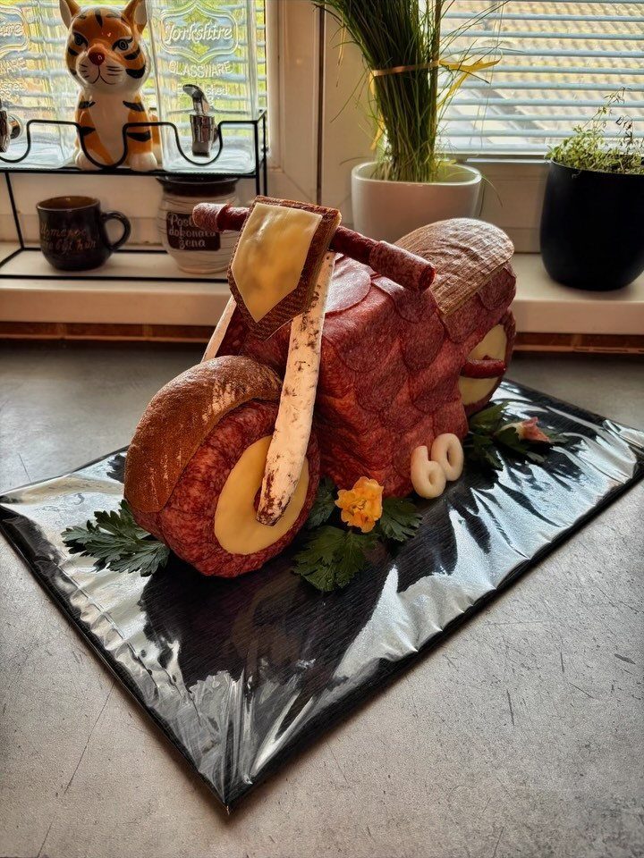 Motorcycle sculpture made of meat and cheese with number 60 for a birthday.