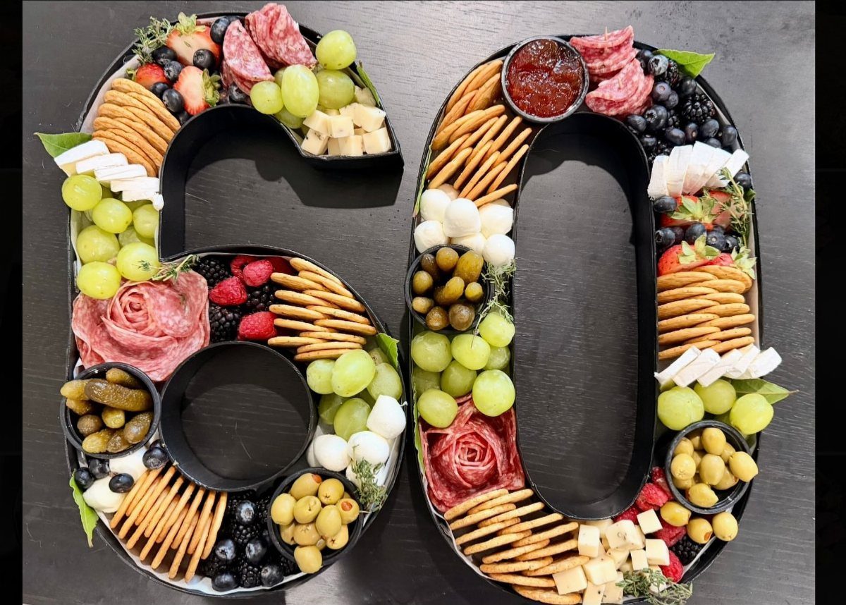 Charcuterie board shaped like the number 60 with meats, cheeses, and fruits.