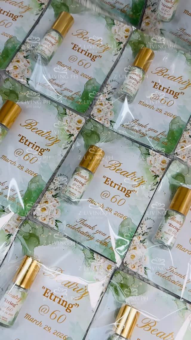 Perfume bottle party favors on floral cards for a 60th birthday celebration
