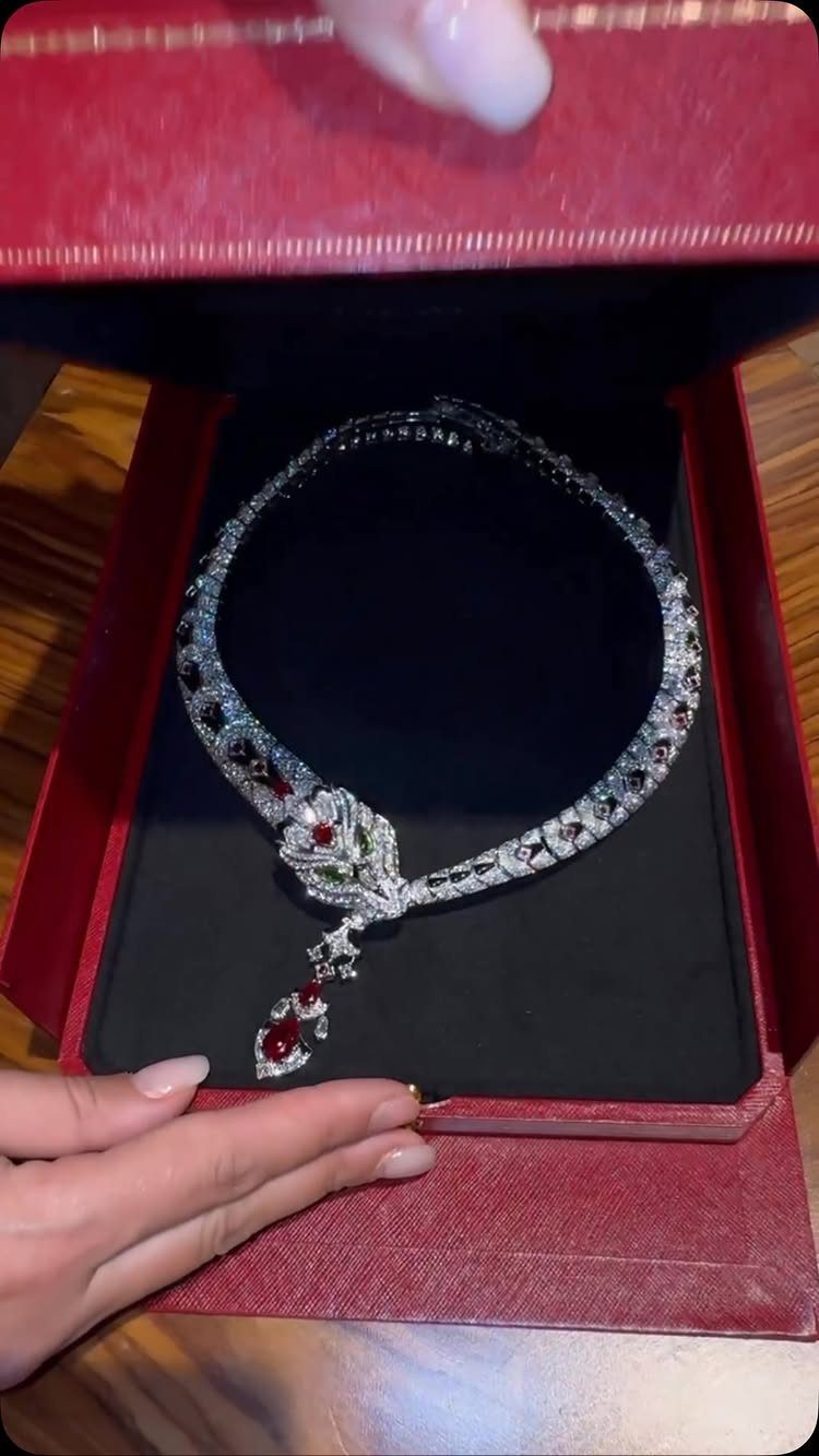 Diamond necklace with red rose pendant in a red velvet jewelry box