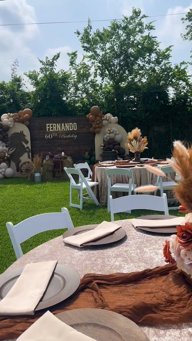 Outdoor 60th birthday party setup with brown and beige decor and horse silhouette.