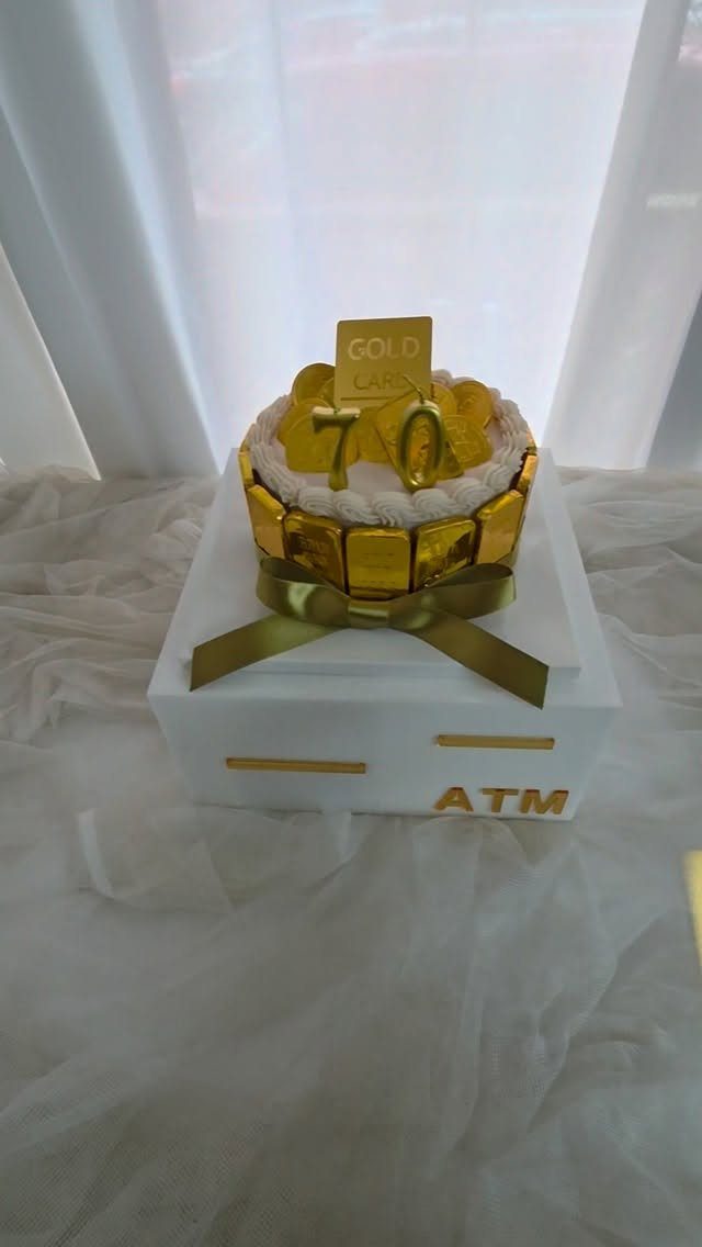 ATM-themed gift box with gold chocolates and a gold 70th birthday topper.