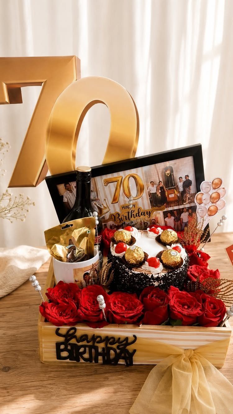 Birthday gift hamper with chocolate cake, red roses, wine, and gold 70 numbers.