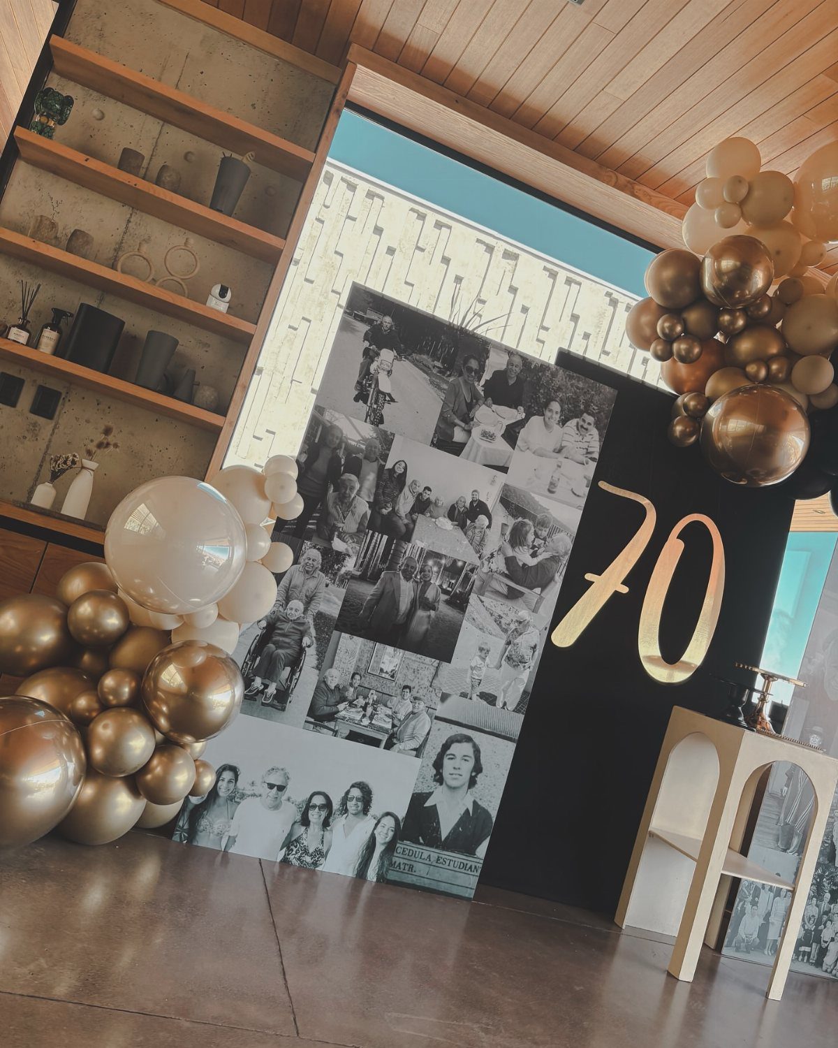 70th birthday backdrop with gold number 70, vintage photo collage, and balloons.