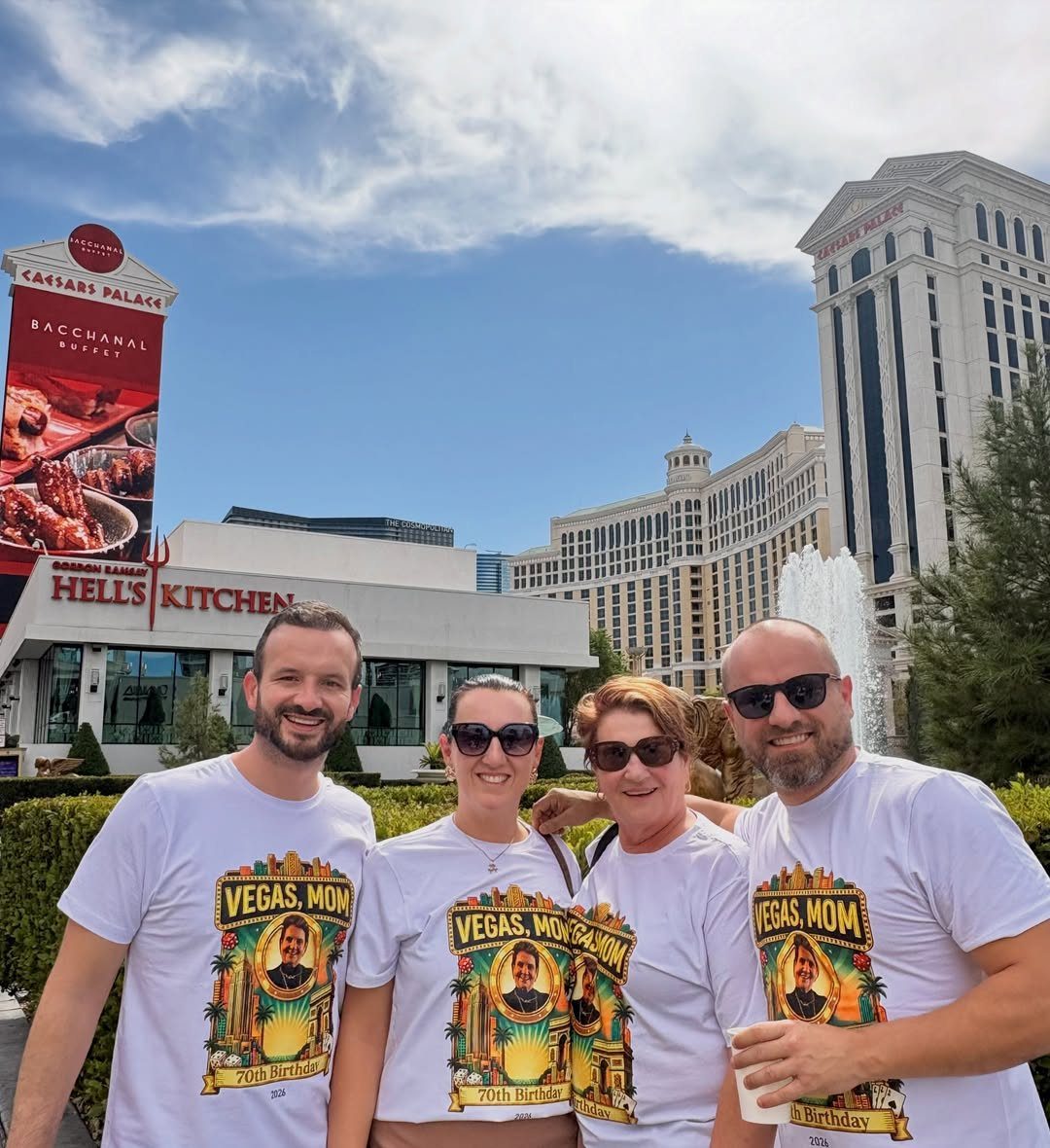 Four adults in matching Vegas Mom 70th Birthday shirts posing in Las Vegas.