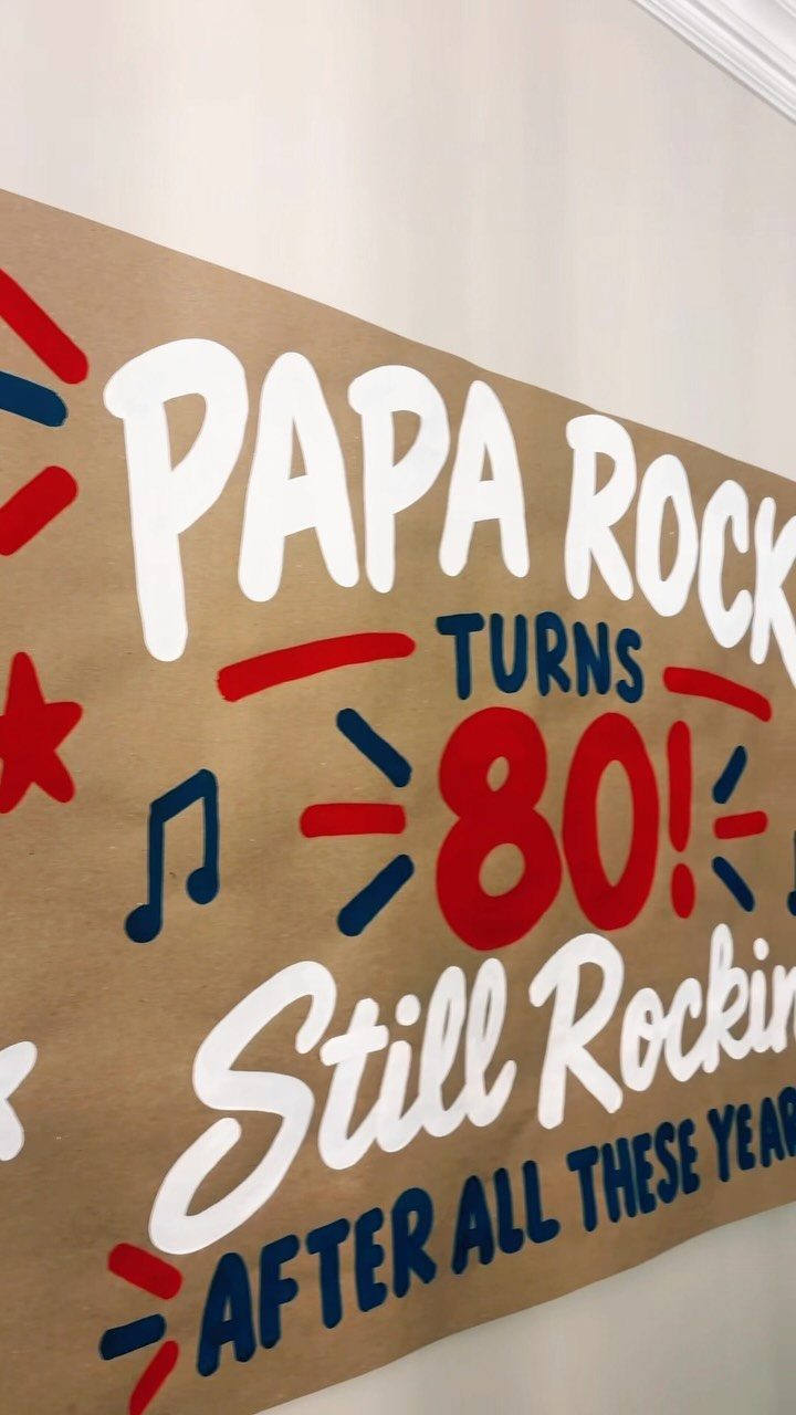 Brown birthday banner for an 80th birthday with rock and roll theme text.