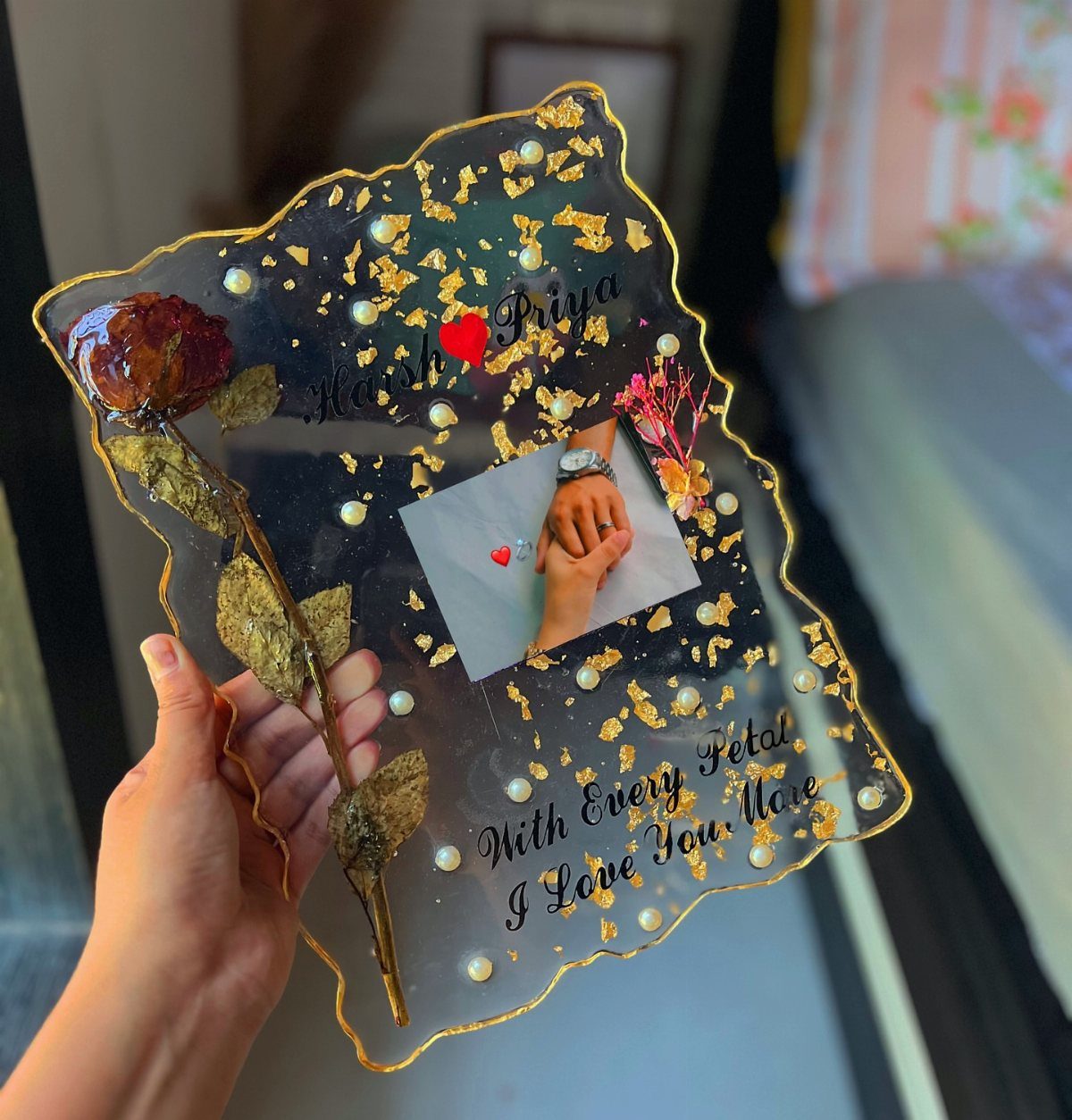 Custom resin art piece with gold flakes, a preserved rose, and a photo.