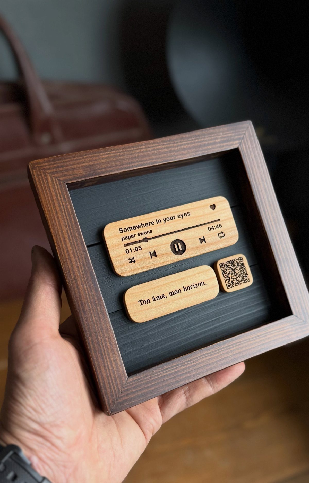 Wooden framed shadow box featuring a carved music player and song lyrics.