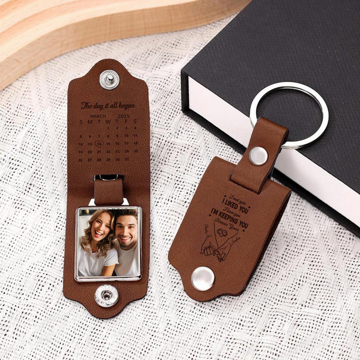 Two brown leather personalized keychains featuring a couple's photo and a calendar date.