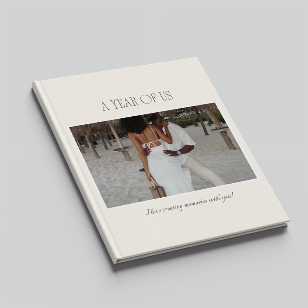 White hardcover photo album featuring a couple on a beach and romantic text.