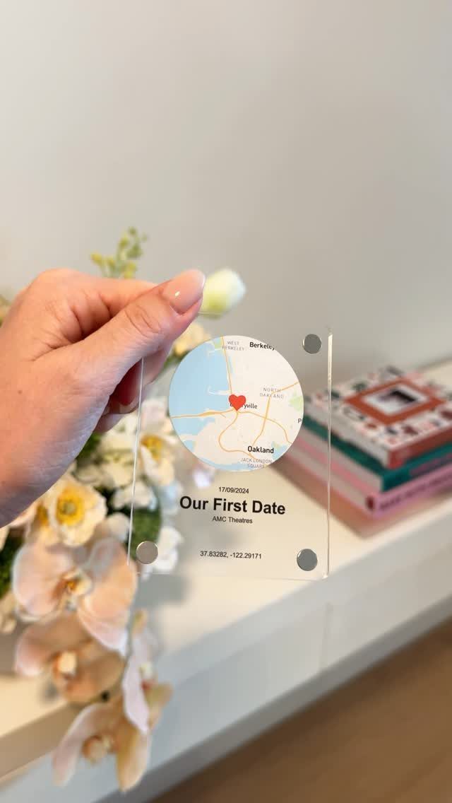 Acrylic plaque with a map and 'Our First Date' text held by hand.