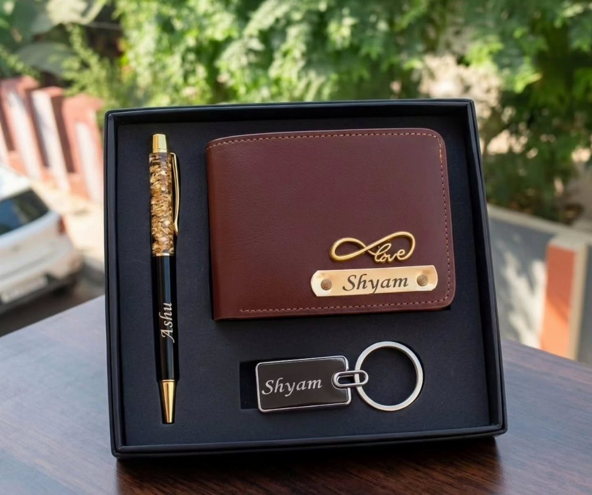 Brown leather wallet, engraved pen, and keychain in a black gift box.